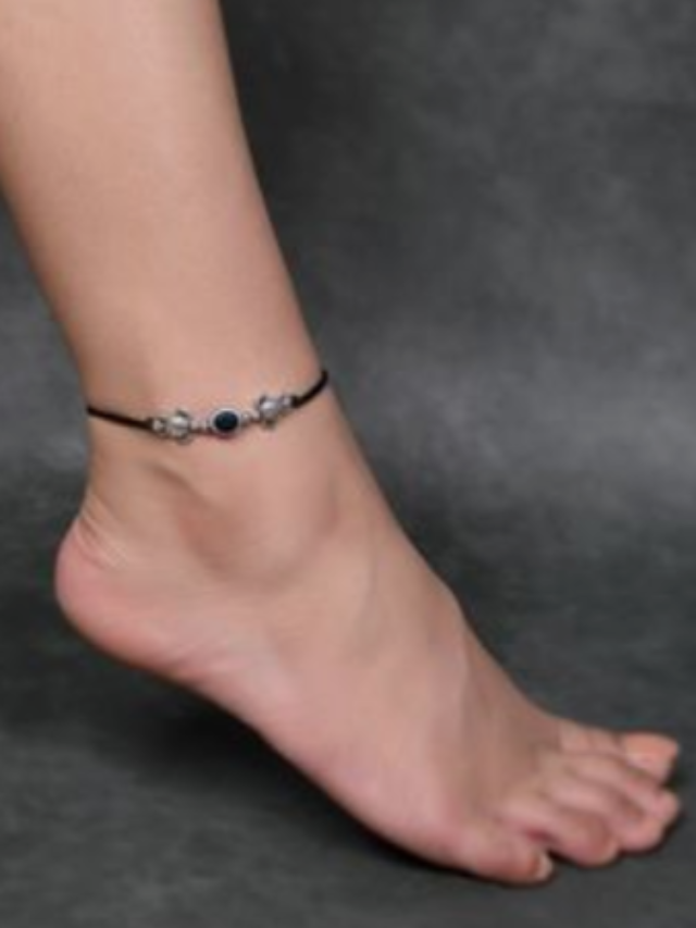 Which part of the body is considered auspicious for tying a black thread